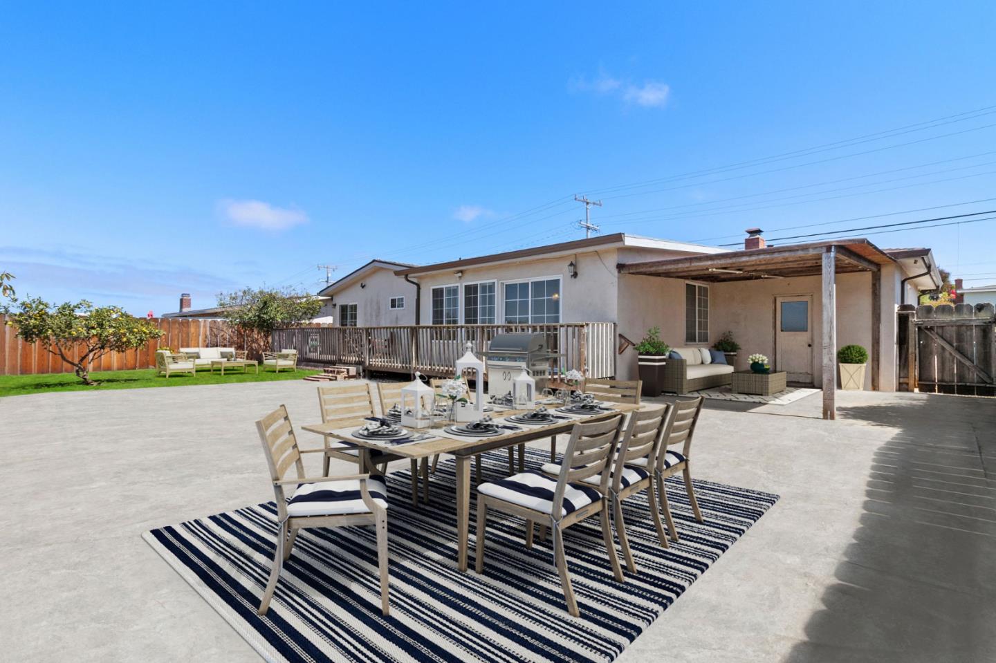 1949 Lincoln Street Seaside, CA 93955 - Photo 29 of 40 a view of a patio with table and chairs with wooden floor and fence