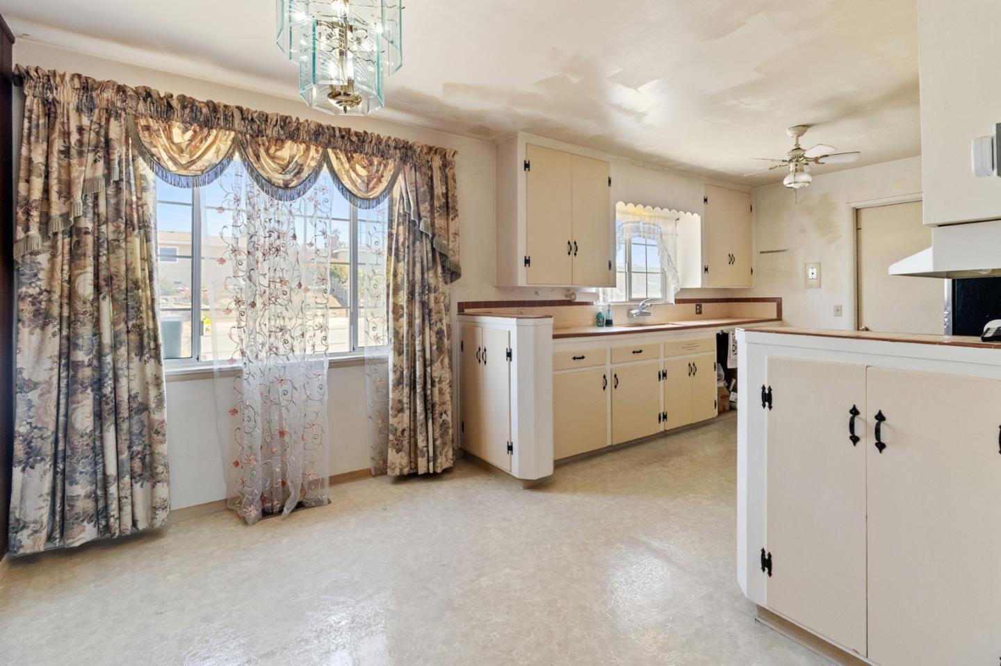 1949 Lincoln Street Seaside, CA 93955 - Photo 7 of 40 a large kitchen with lot of cabinets and outdoor space