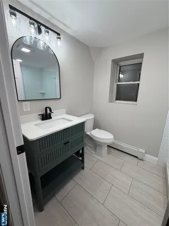 a bathroom with a sink toilet and mirror
