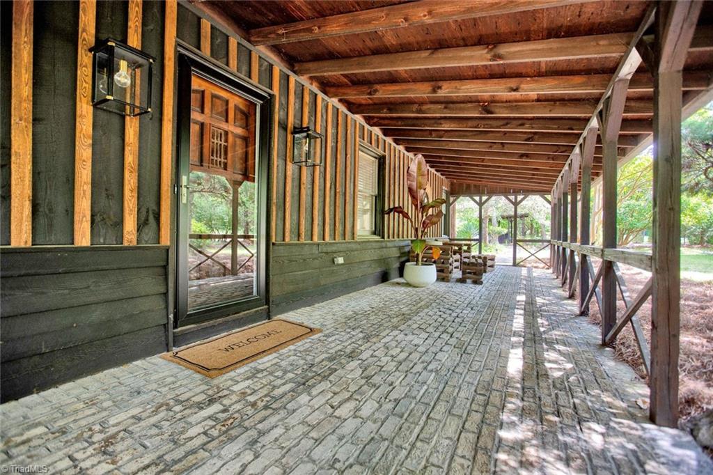 7762 Eversfield Road Summerfield, NC 27358 - Photo 4 of 30 Custom front Veranda! Amazing place to hang out and enjoy the property at the front of the house!