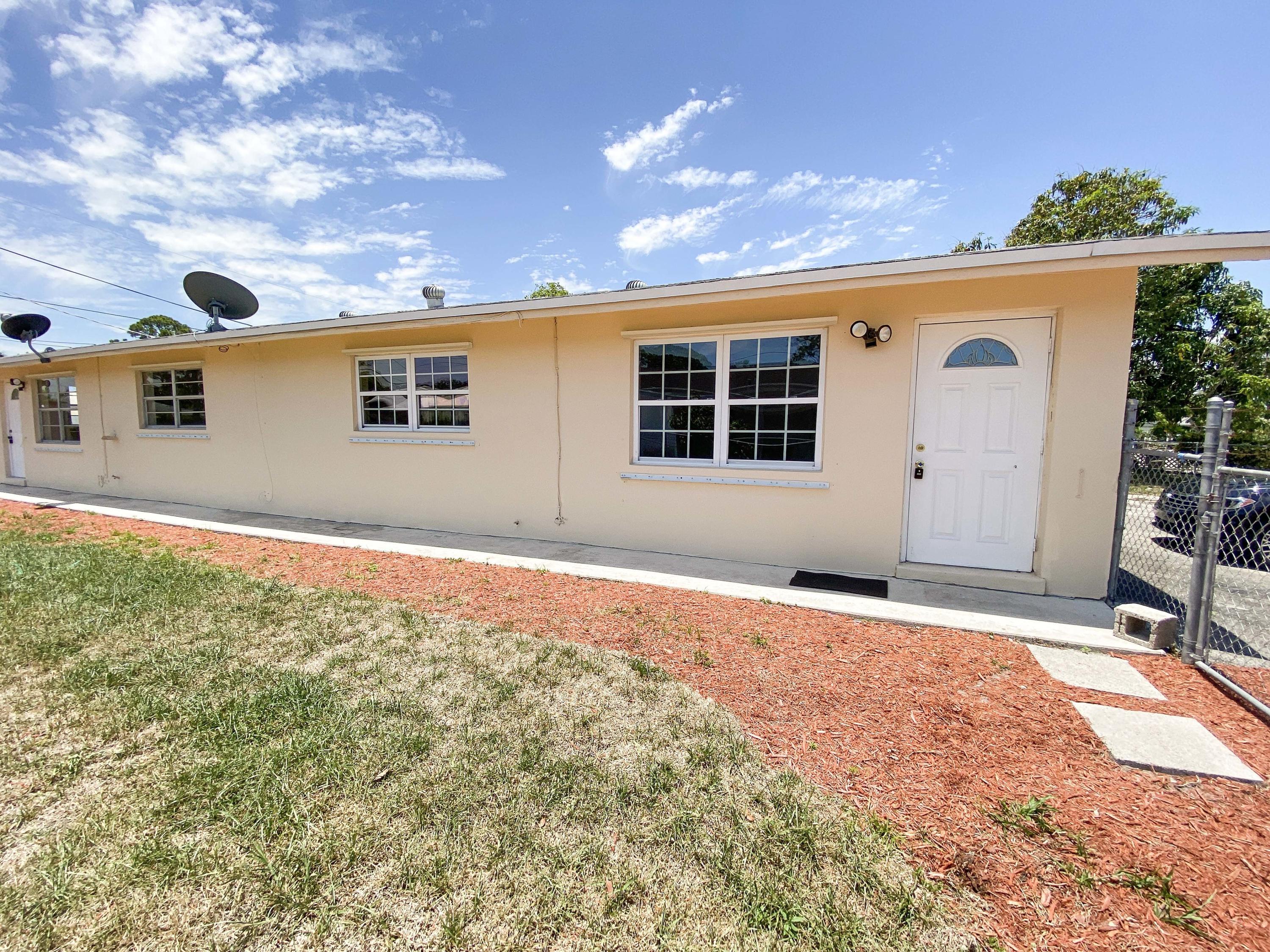 5884 Mango Road, Unit B West Palm Beach, FL 33413 - Photo 1 of 8 a front view of a house with a yard