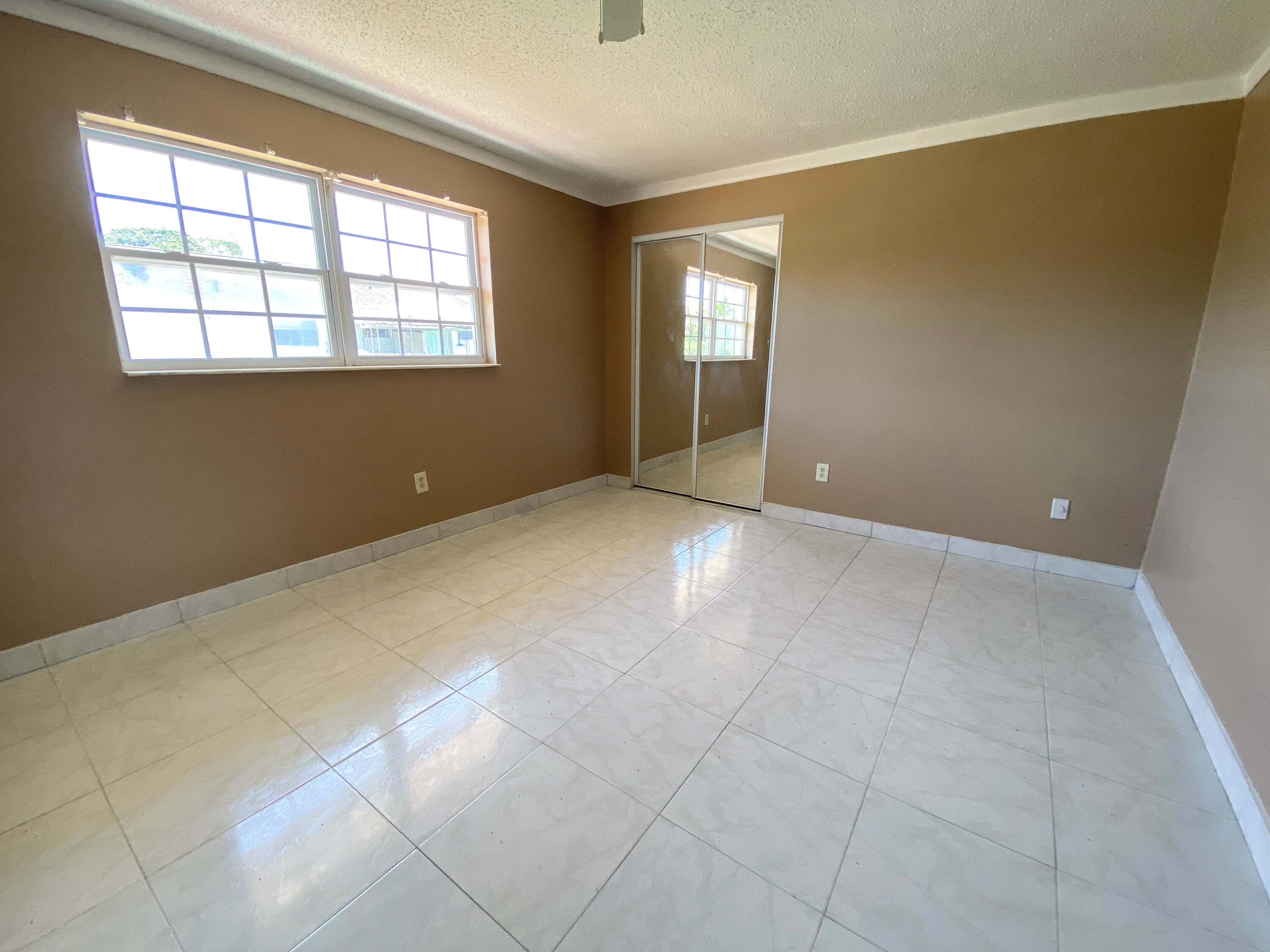 5884 Mango Road, Unit B West Palm Beach, FL 33413 - Photo 4 of 8 an empty room with windows