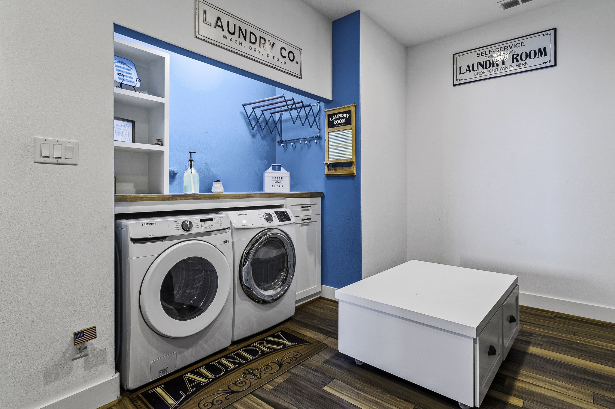 151 Key Largo Loop Point Blank, TX 77364 - Photo 20 of 49 Spacious laundry room features built-in storage, folding station, hanging rack, and convenient center island for added organization.