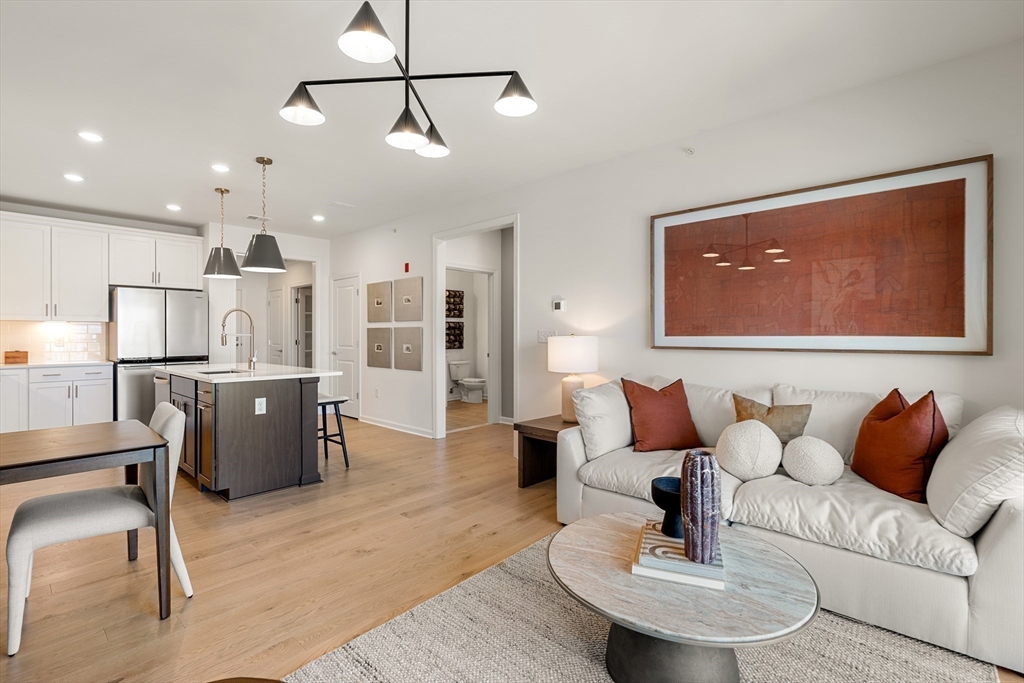 a living room with furniture and kitchen view