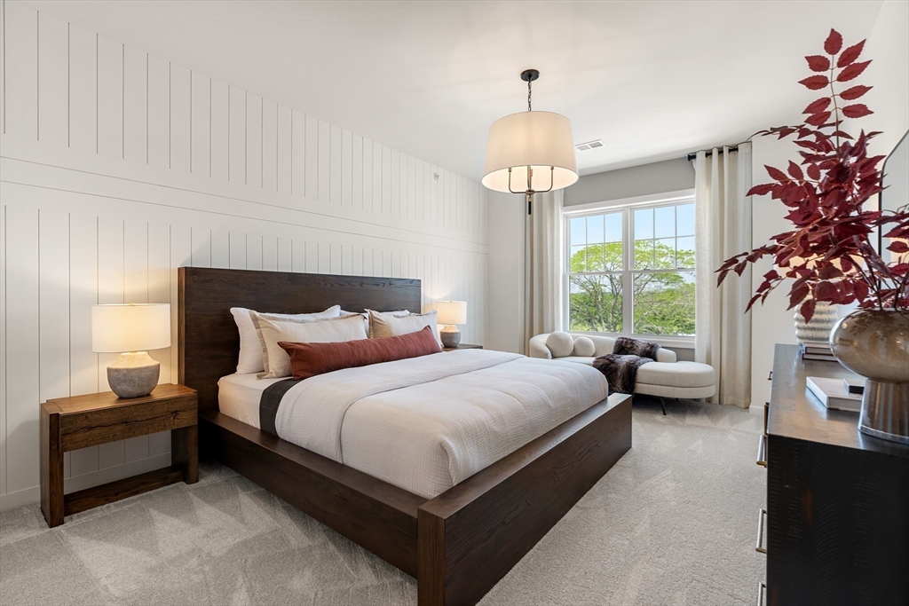 6 Stratton Drive, Unit 3303 Woburn, MA 01801 - Photo 20 of 30 a bedroom with bed and a chandelier