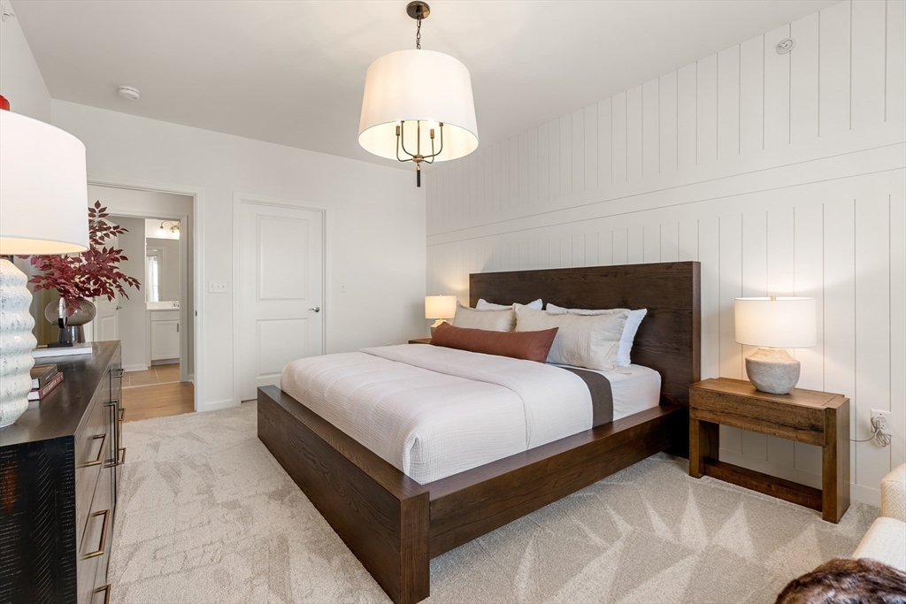 6 Stratton Drive, Unit 3303 Woburn, MA 01801 - Photo 21 of 30 a bedroom with bed and a chandelier