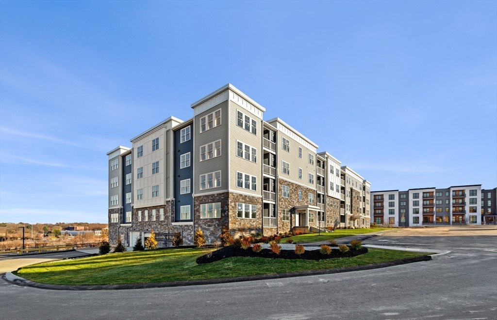 6 Stratton Drive, Unit 3303 Woburn, MA 01801 - Photo 29 of 30 a view of a tall building next to a yard