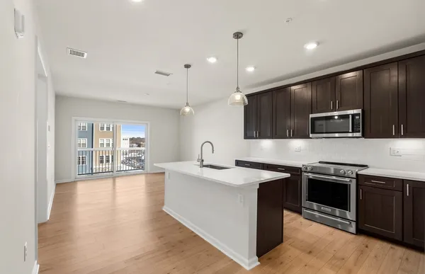 a kitchen with stainless steel appliances kitchen island a sink and a stove