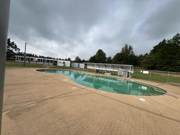 a view of swimming pool with a yard