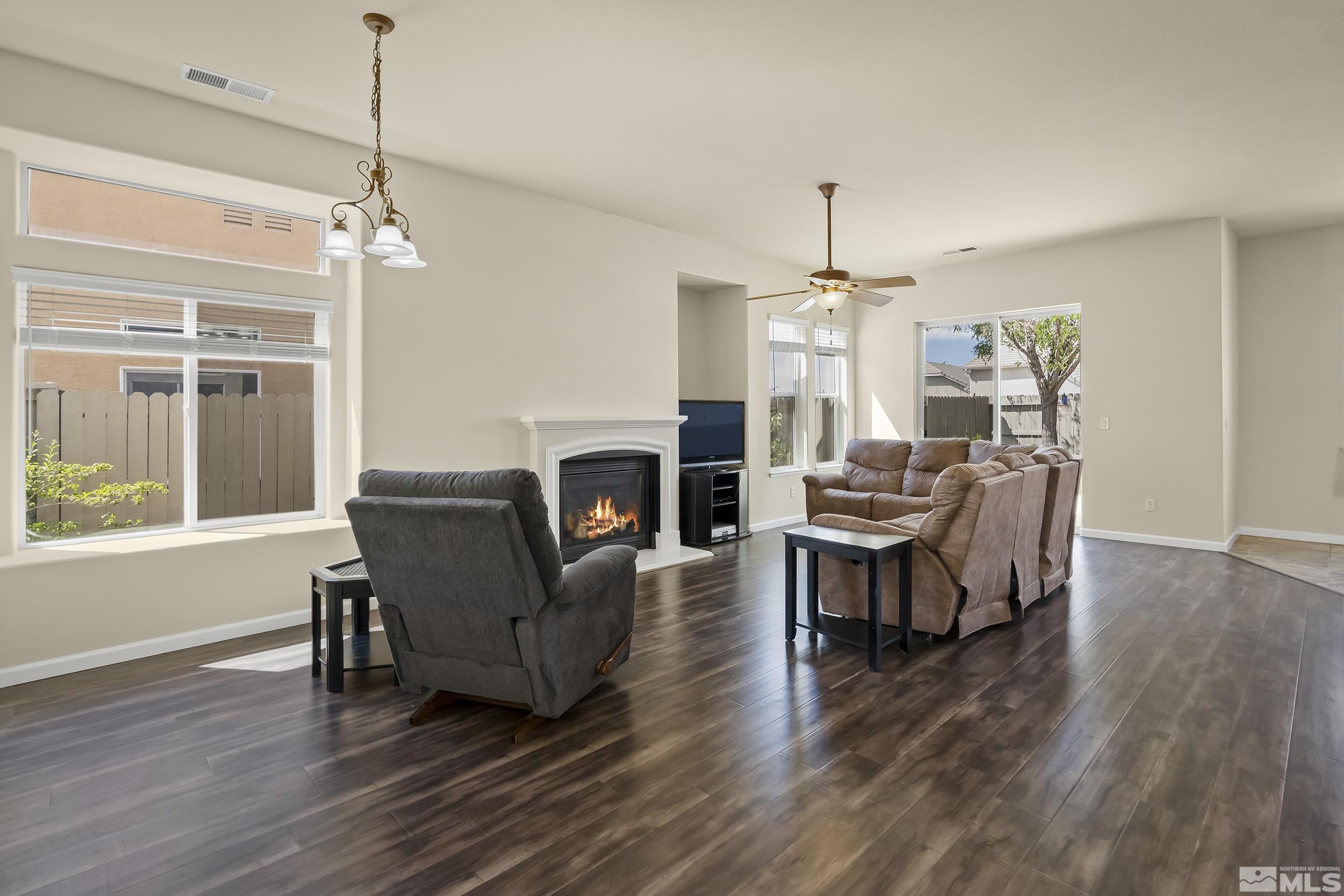 1615 Sewell Drive Reno, NV 89521 - Photo 5 of 25 a living room with furniture a fireplace and wooden floor