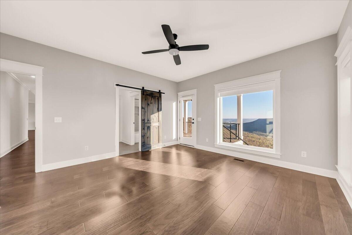 155 Riverview Drive Jasper, TN 37347 - Photo 56 of 100 a view of empty room with wooden floor and fan