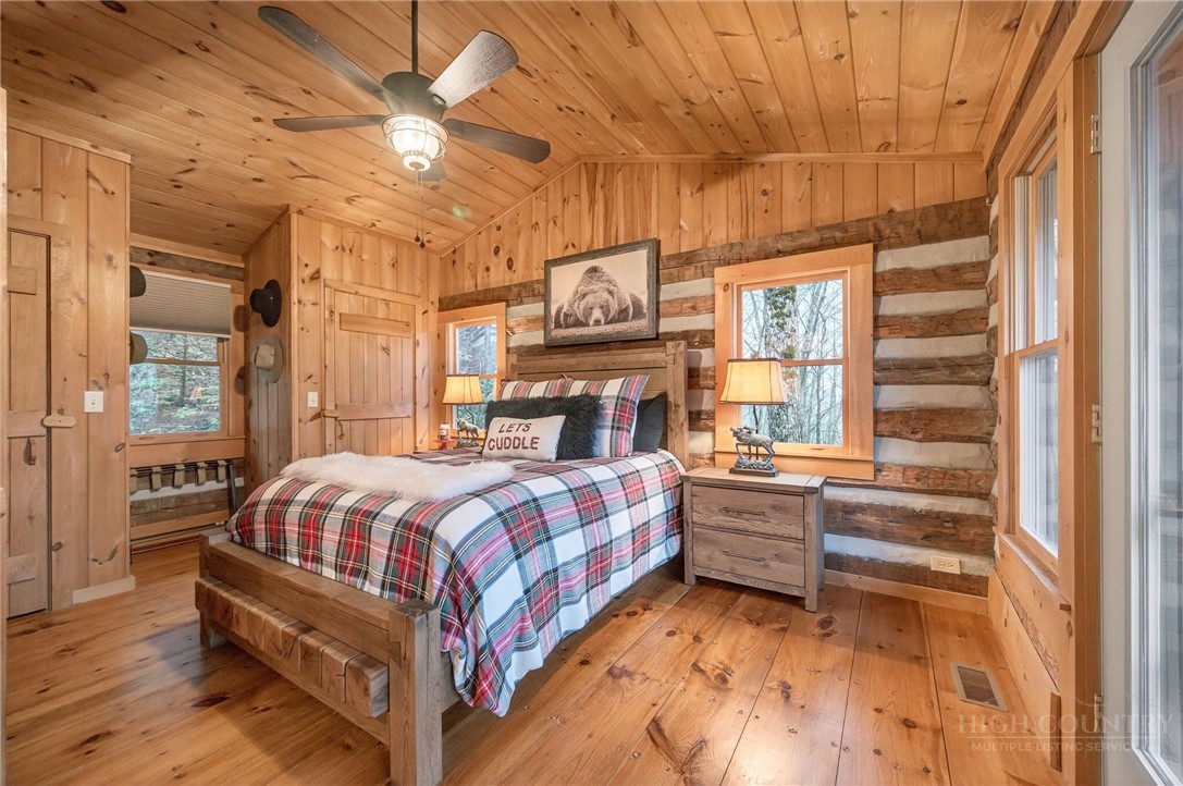 376 Yellow Bear Road Todd, NC 28684 - Photo 13 of 29 a bedroom with a bed and wooden floor