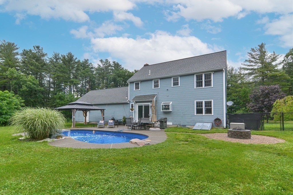 a house view with swimming pool and garden space
