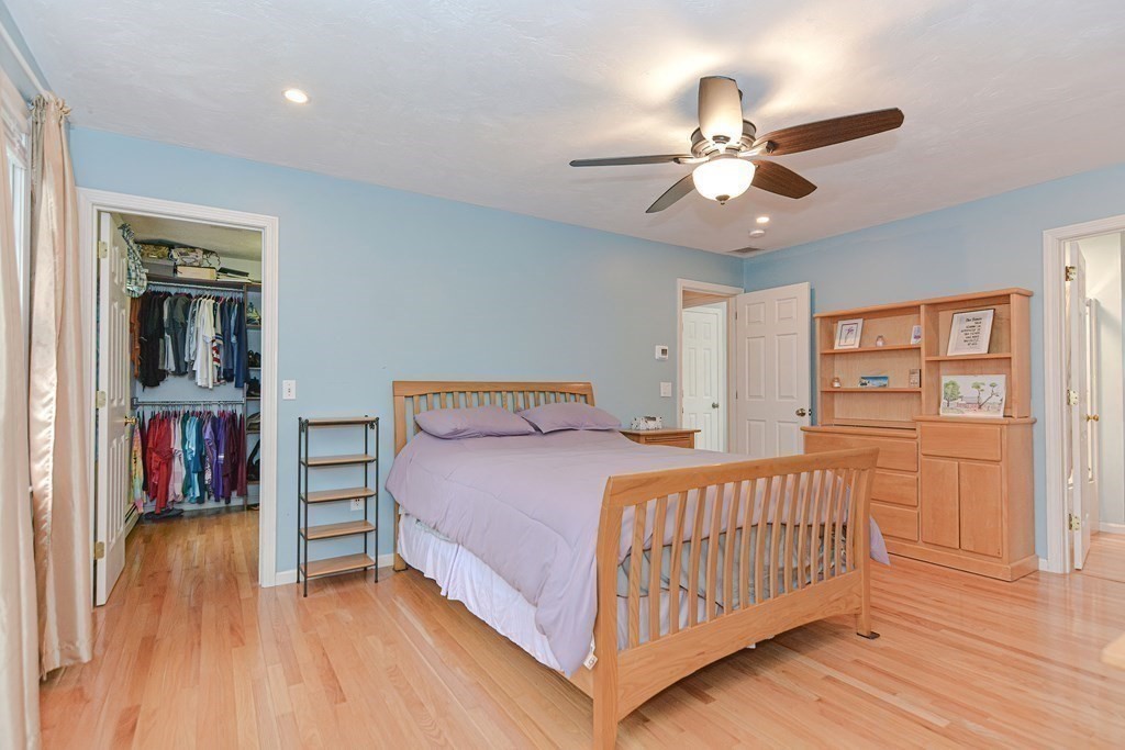 5 Post Road Foxboro, MA 02035 - Photo 17 of 37 a bedroom with a bed and a chandelier