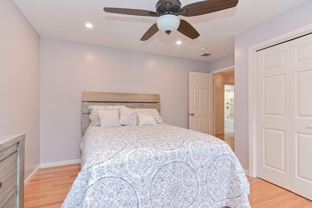 5 Post Road Foxboro, MA 02035 - Photo 28 of 37 a bedroom with a bed and a chandelier