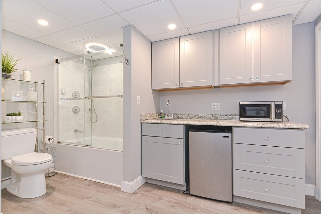 5 Post Road Foxboro, MA 02035 - Photo 36 of 37 a bathroom with a granite countertop sink a toilet and shower
