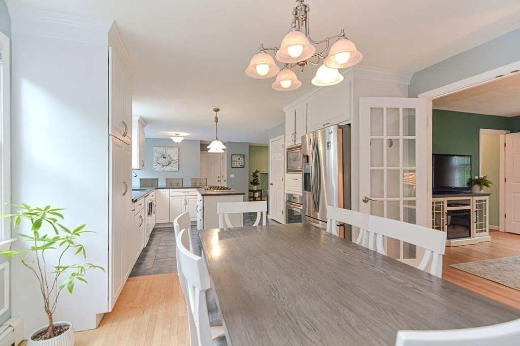 5 Post Road Foxboro, MA 02035 - Photo 10 of 37 a view of a dining room with furniture a potted plant and wooden floor