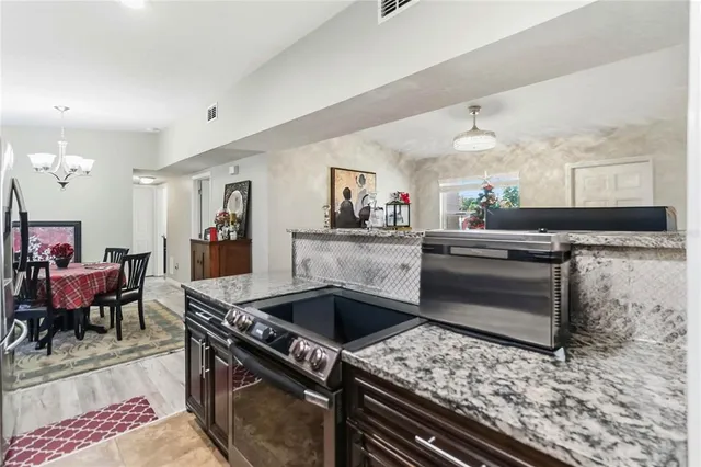 a kitchen with a stove a sink and a refrigerator