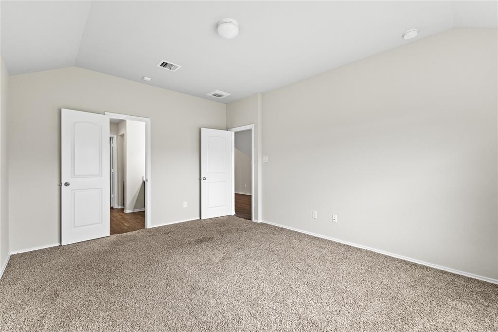 15454 Arce Rojo Street Channelview, TX 77530 - Photo 17 of 32 Unfurnished bedroom featuring vaulted ceiling and carpet