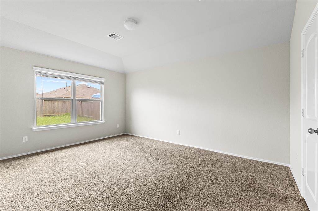 15454 Arce Rojo Street Channelview, TX 77530 - Photo 21 of 32 Empty room with carpet floors and vaulted ceiling
