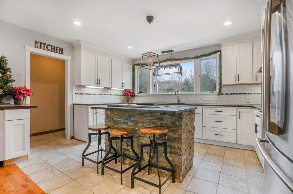 5 Maple Road Warren, RI 02885 - Photo 8 of 41 a kitchen with cabinets a window and appliances