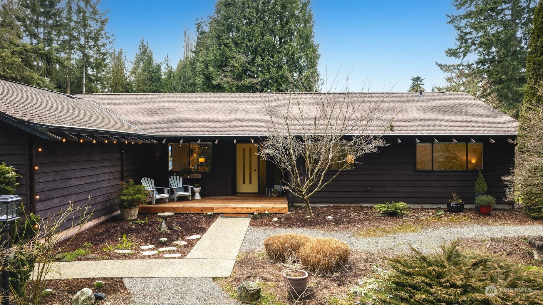 a view of house with yard and sitting area
