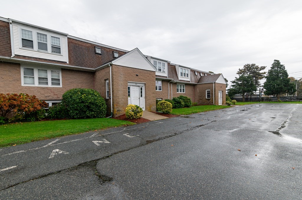 24 Bettys Pond Road, Unit K Barnstable, MA 02601 - Photo 3 of 16 a front view of a house with garden