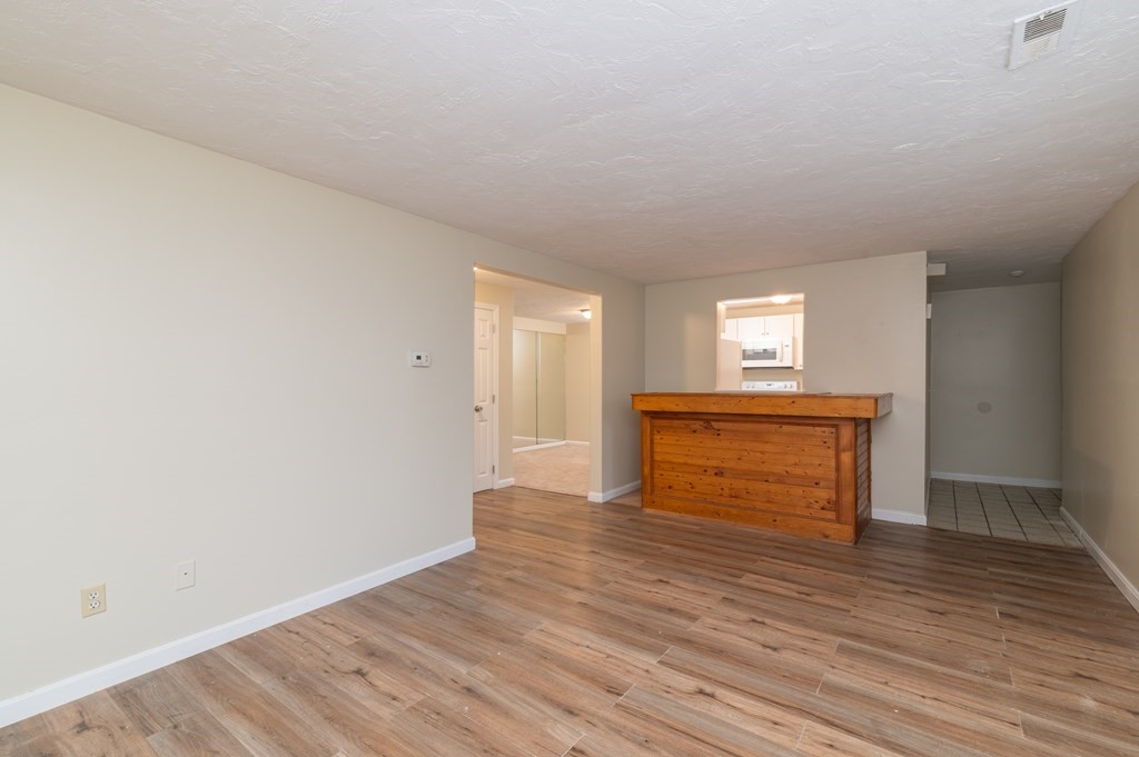 24 Bettys Pond Road, Unit K Barnstable, MA 02601 - Photo 5 of 16 a view of empty room with wooden floor