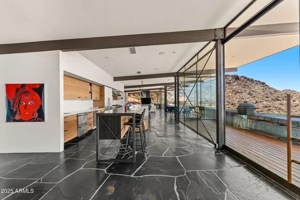 a living room with couch a flat screen tv and a floor to ceiling window