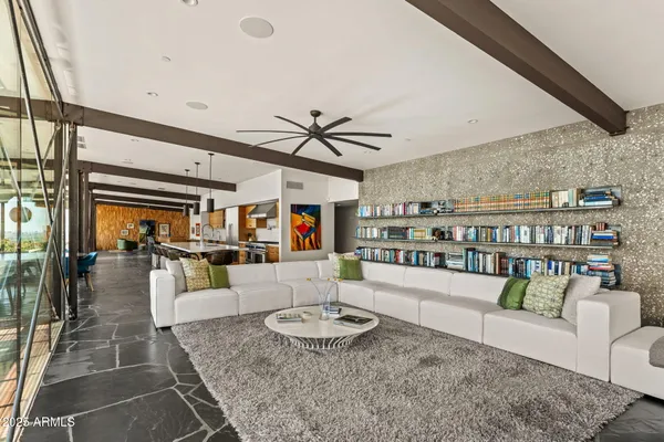 a view of a hallway with wooden floor and windows