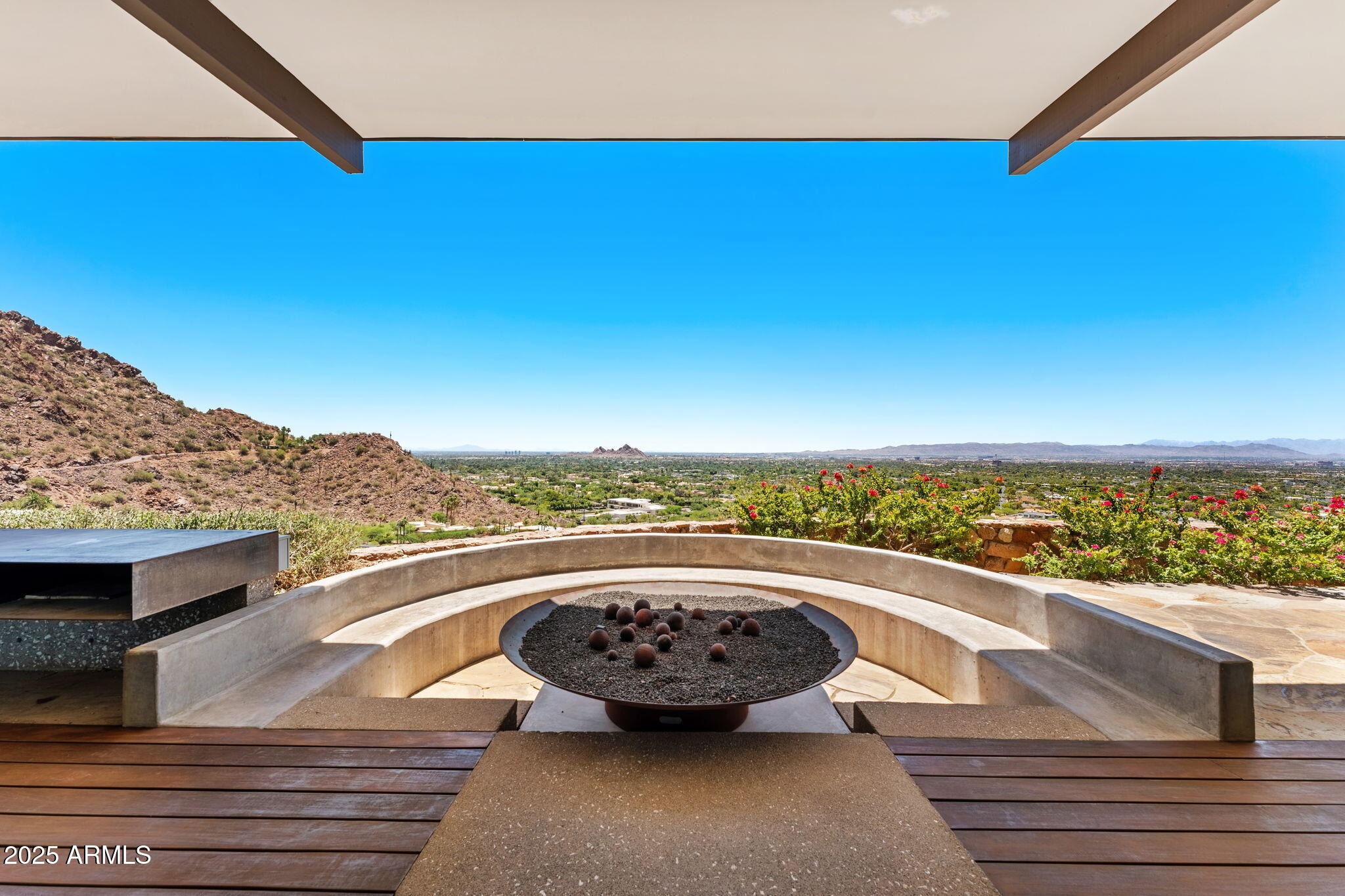 4925 East Red Rock Drive, Unit 43 Phoenix, AZ 85018 - Photo 37 of 99 a view of a terrace with wooden floor and a ocean view