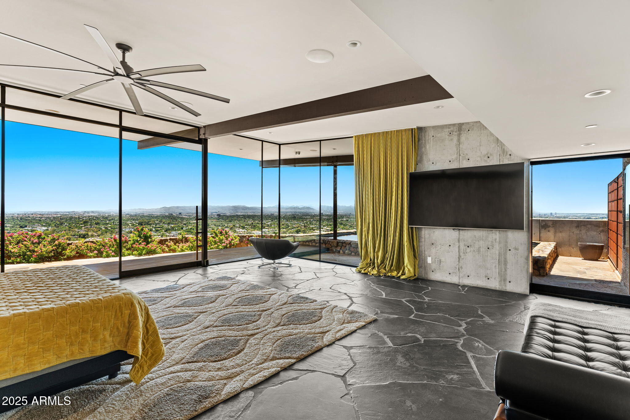 4925 East Red Rock Drive, Unit 43 Phoenix, AZ 85018 - Photo 42 of 99 a living room with couch a flat screen tv and a floor to ceiling window