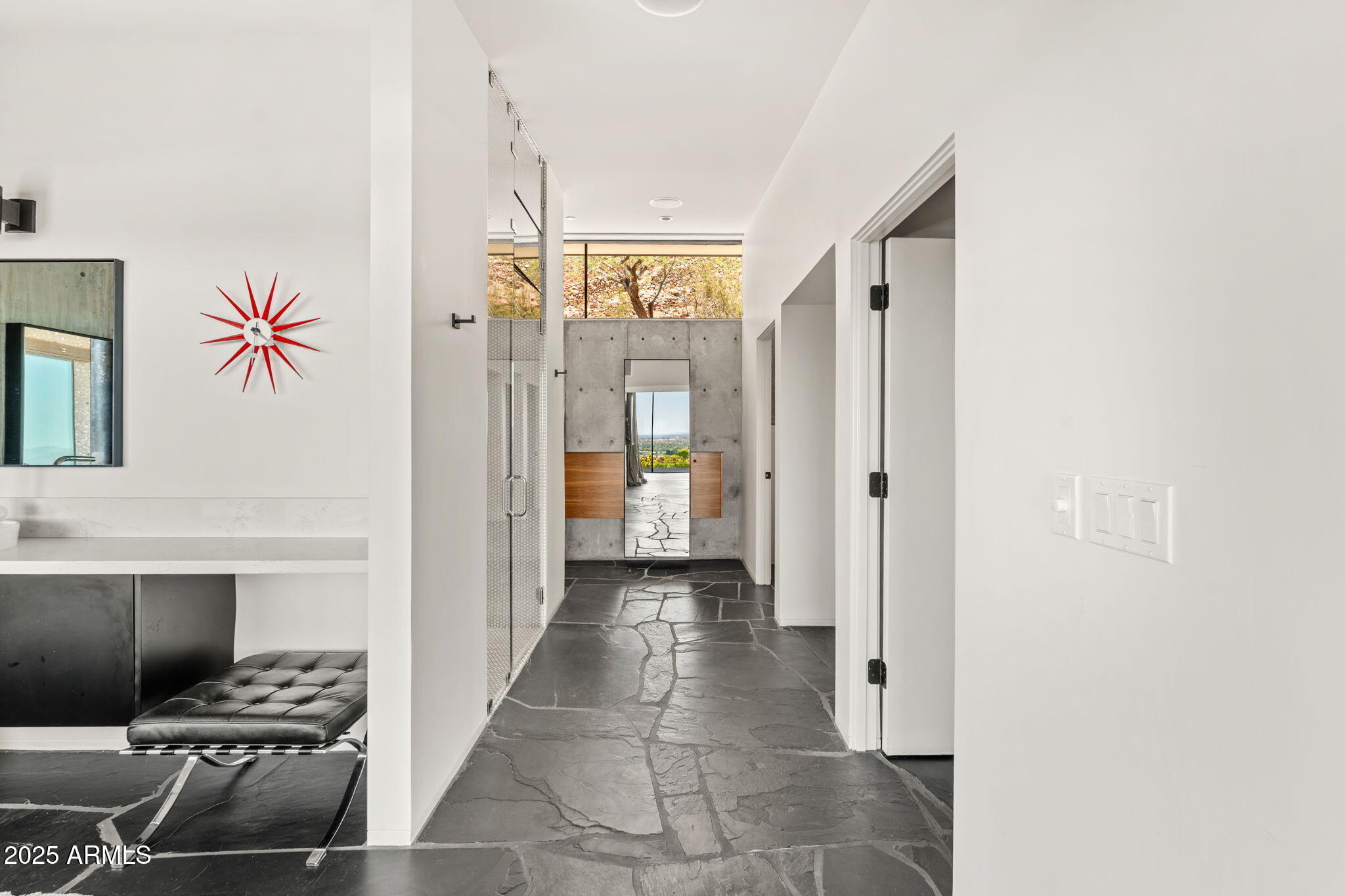 4925 East Red Rock Drive, Unit 43 Phoenix, AZ 85018 - Photo 51 of 99 a view of a hallway to a livingroom with furniture and windows