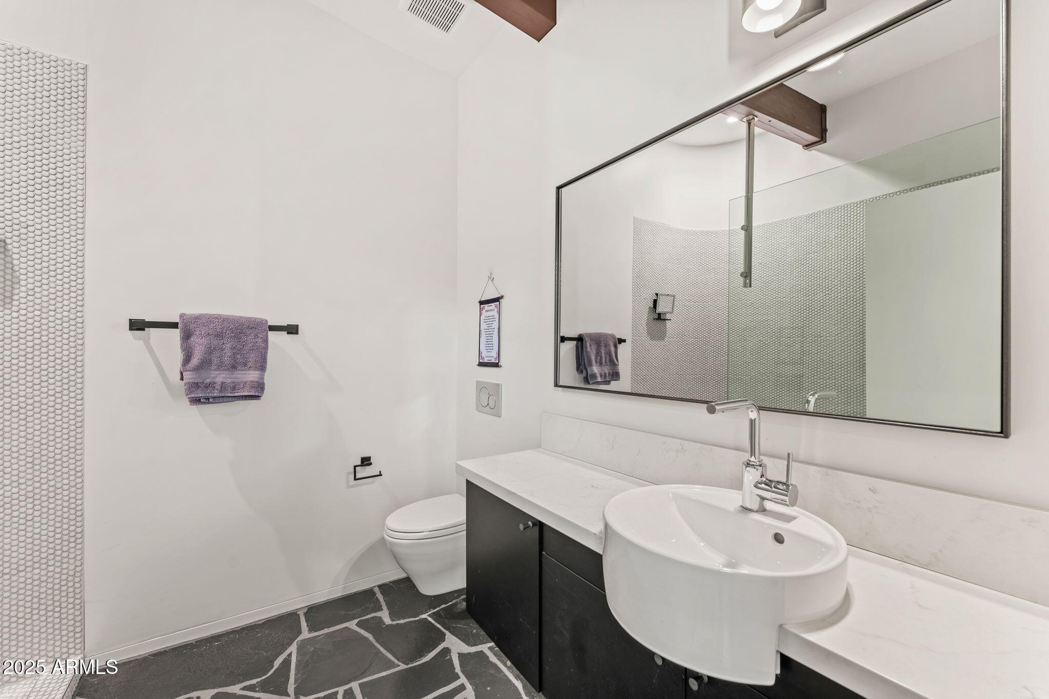 4925 East Red Rock Drive, Unit 43 Phoenix, AZ 85018 - Photo 53 of 99 a bathroom with a sink and a mirror