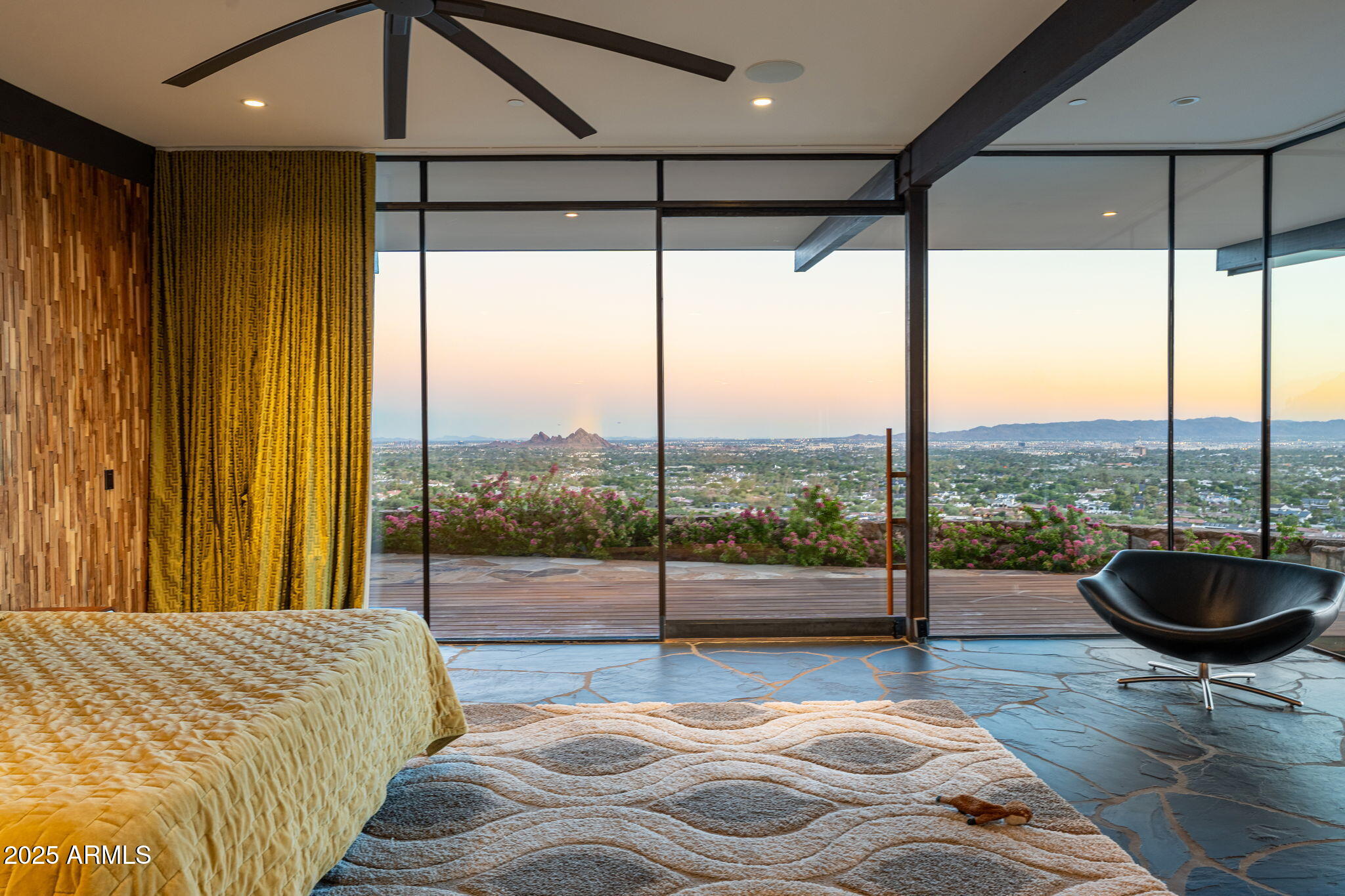 4925 East Red Rock Drive, Unit 43 Phoenix, AZ 85018 - Photo 90 of 99 a spacious bedroom with a large window and a table