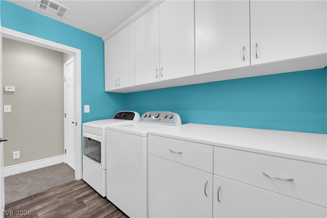 646 Monument Point Street Henderson, NV 89002 - Photo 19 of 44 Functional laundry room offers a convenient washer, dryer, and ample storage cabinetry.