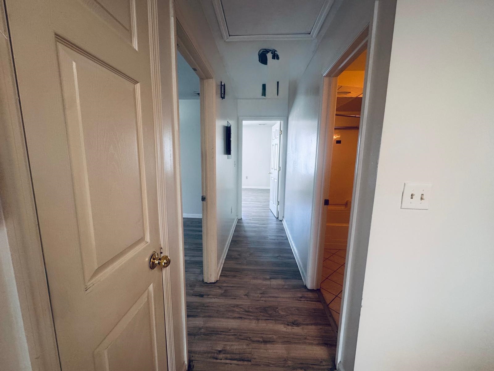 161 West 53rd Street, Unit 2 Bayonne, NJ 07002 - Photo 11 of 19 a view of a hallway with wooden floor and staircase