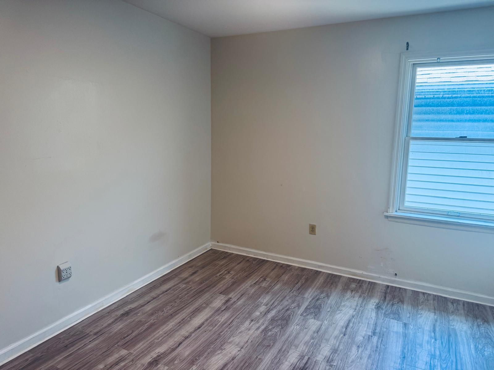 161 West 53rd Street, Unit 2 Bayonne, NJ 07002 - Photo 6 of 19 a view of a room with wooden floor and window