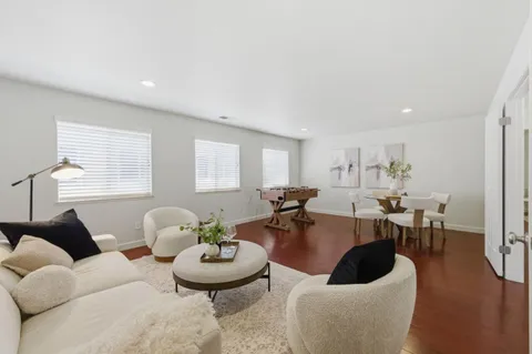 a living room with furniture a wooden floor and a window