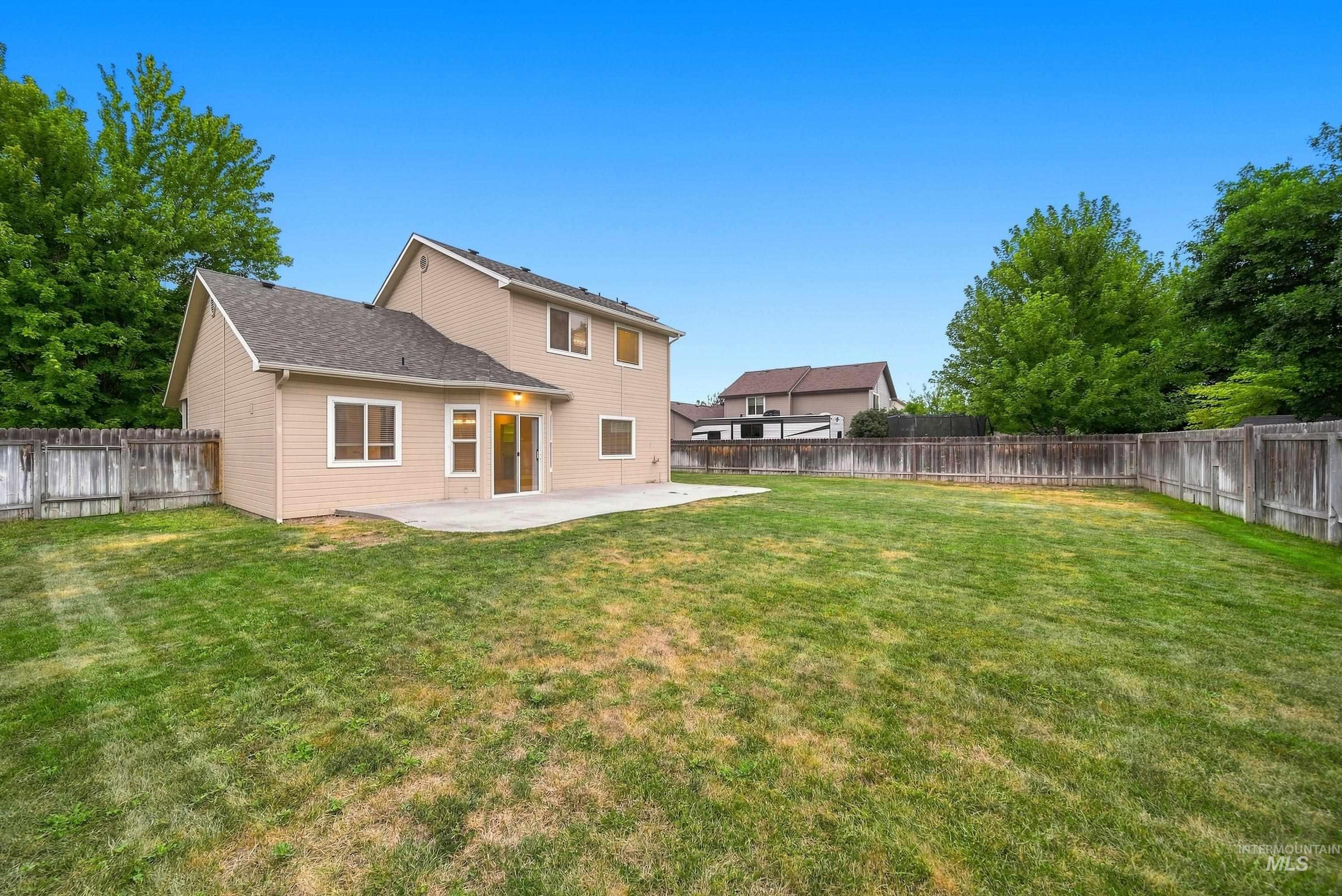 919 East Hawk Street Meridian, ID 83646 - Photo 31 of 31 Expansive fenced yard with a concrete patio and mature perimeter trees