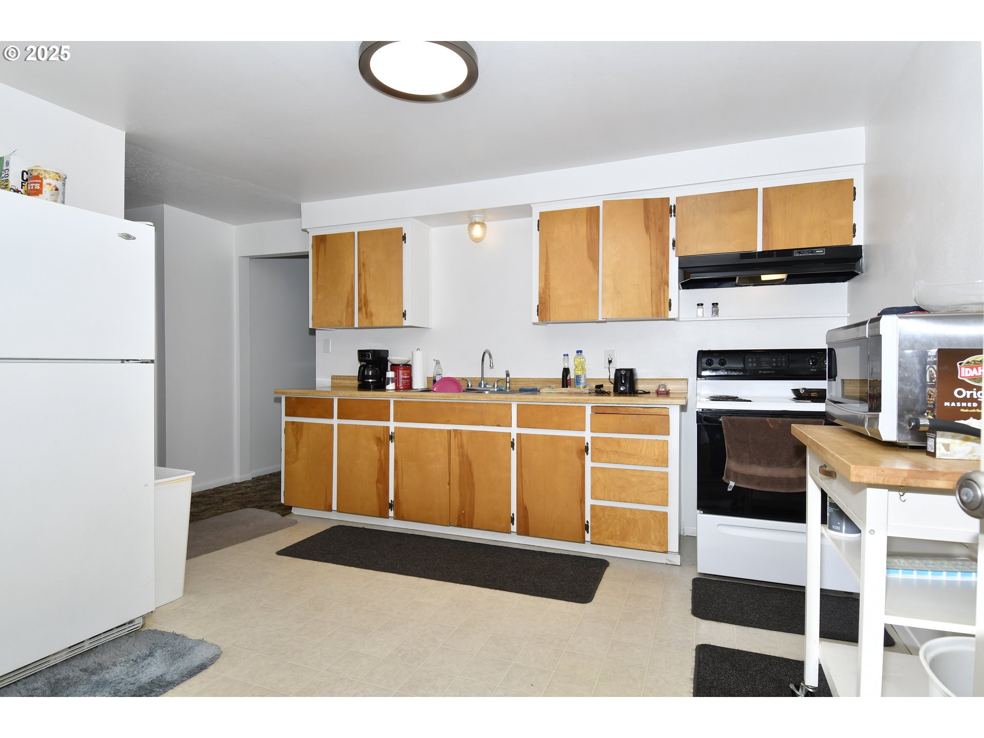1126 South Jasper Street Cornelius, OR 97113 - Photo 11 of 47 a kitchen with stainless steel appliances kitchen island granite countertop a refrigerator a stove top oven a sink and dishwasher