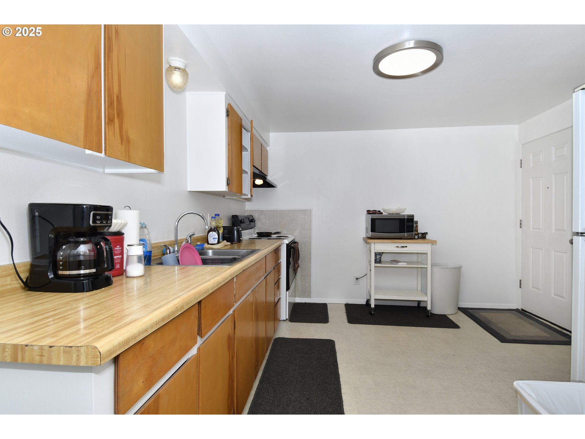 1126 South Jasper Street Cornelius, OR 97113 - Photo 14 of 47 a kitchen with kitchen island a sink stainless steel appliances and cabinets