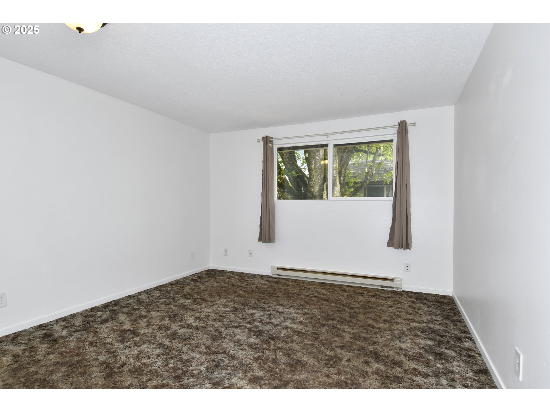 1126 South Jasper Street Cornelius, OR 97113 - Photo 18 of 47 an empty room with wooden floor and windows