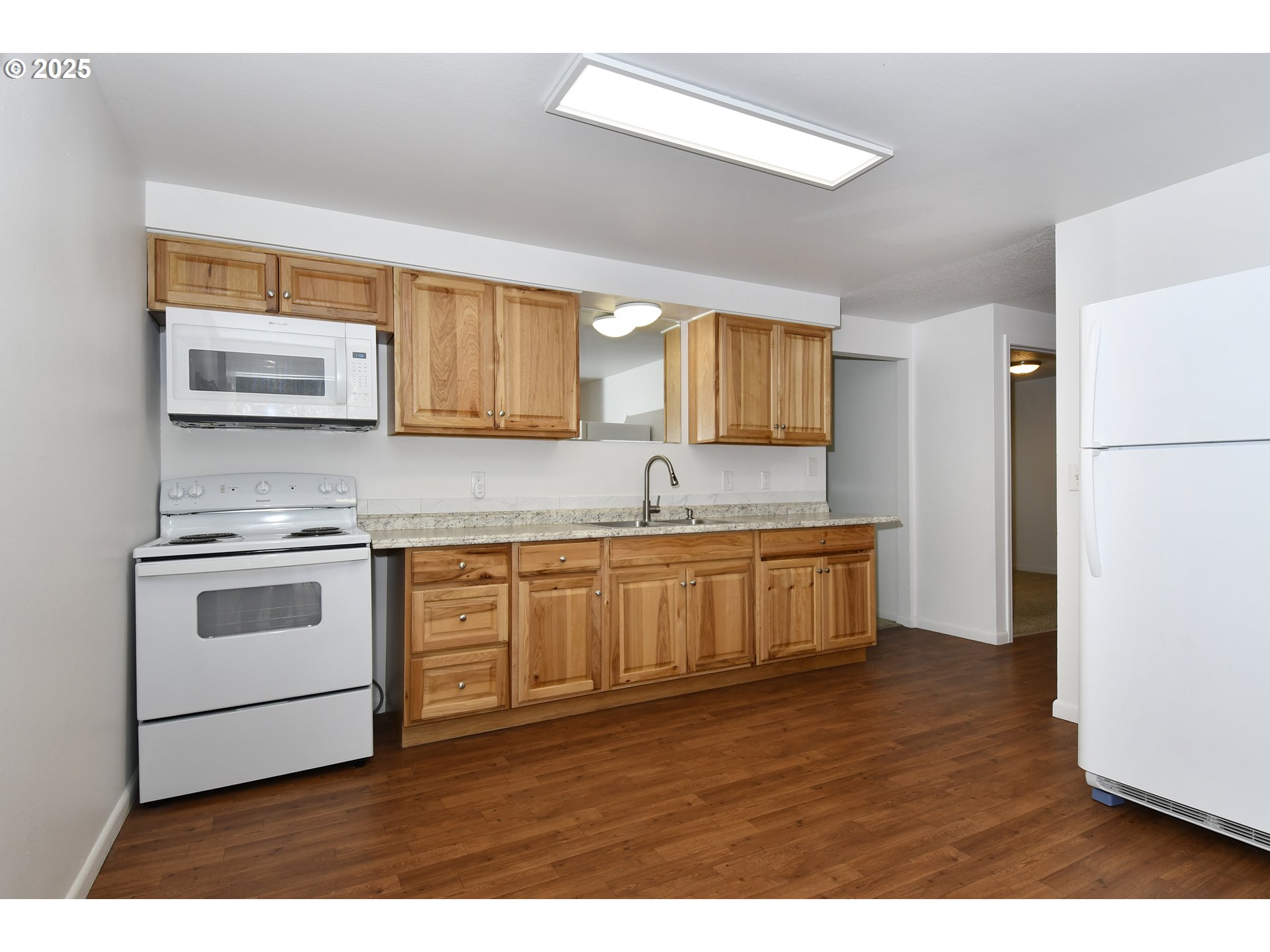 1126 South Jasper Street Cornelius, OR 97113 - Photo 20 of 47 a kitchen with stainless steel appliances white cabinets a sink a stove a refrigerator and a microwave