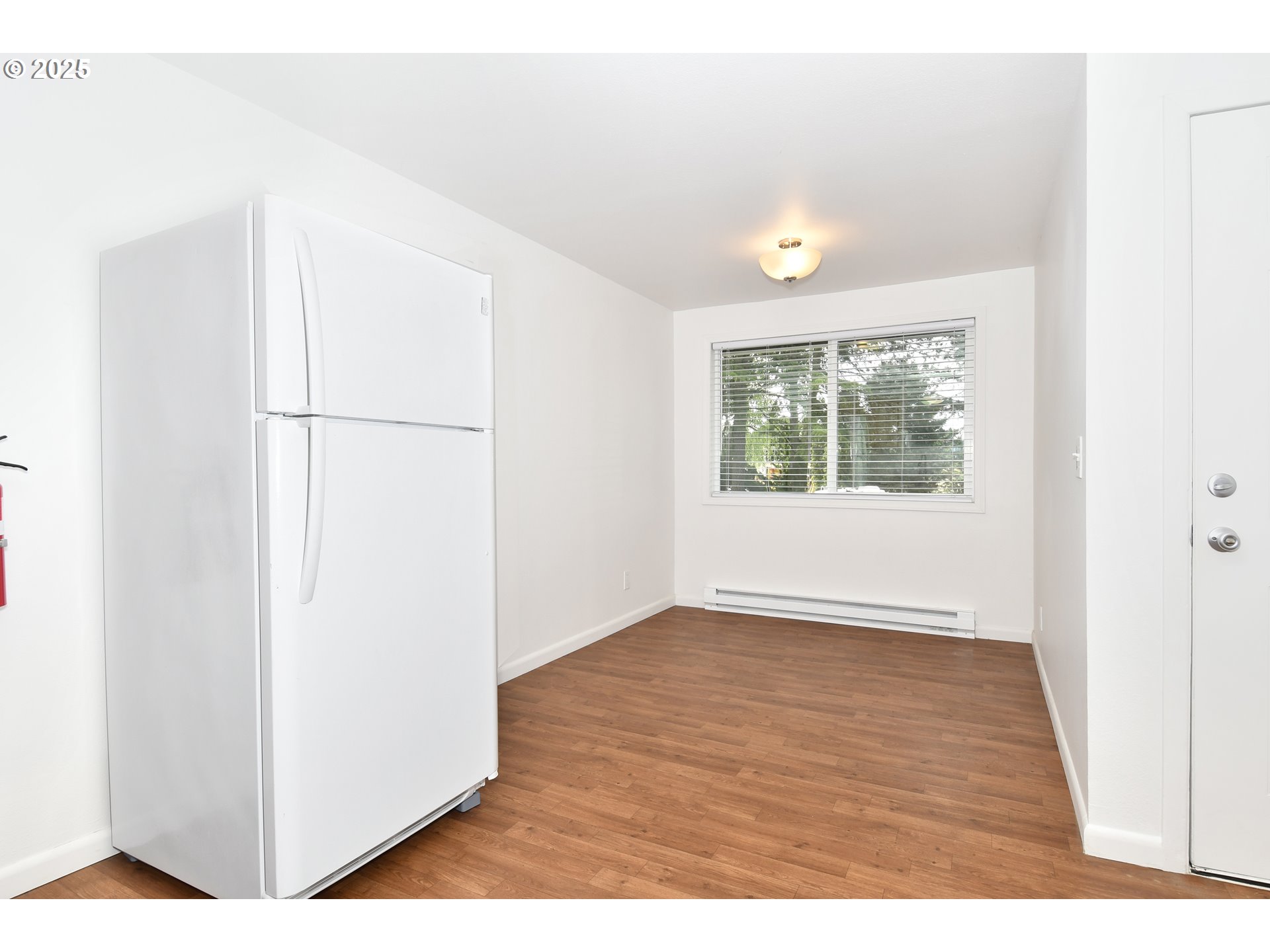 1126 South Jasper Street Cornelius, OR 97113 - Photo 22 of 47 a view of an empty room with wooden floor and a window