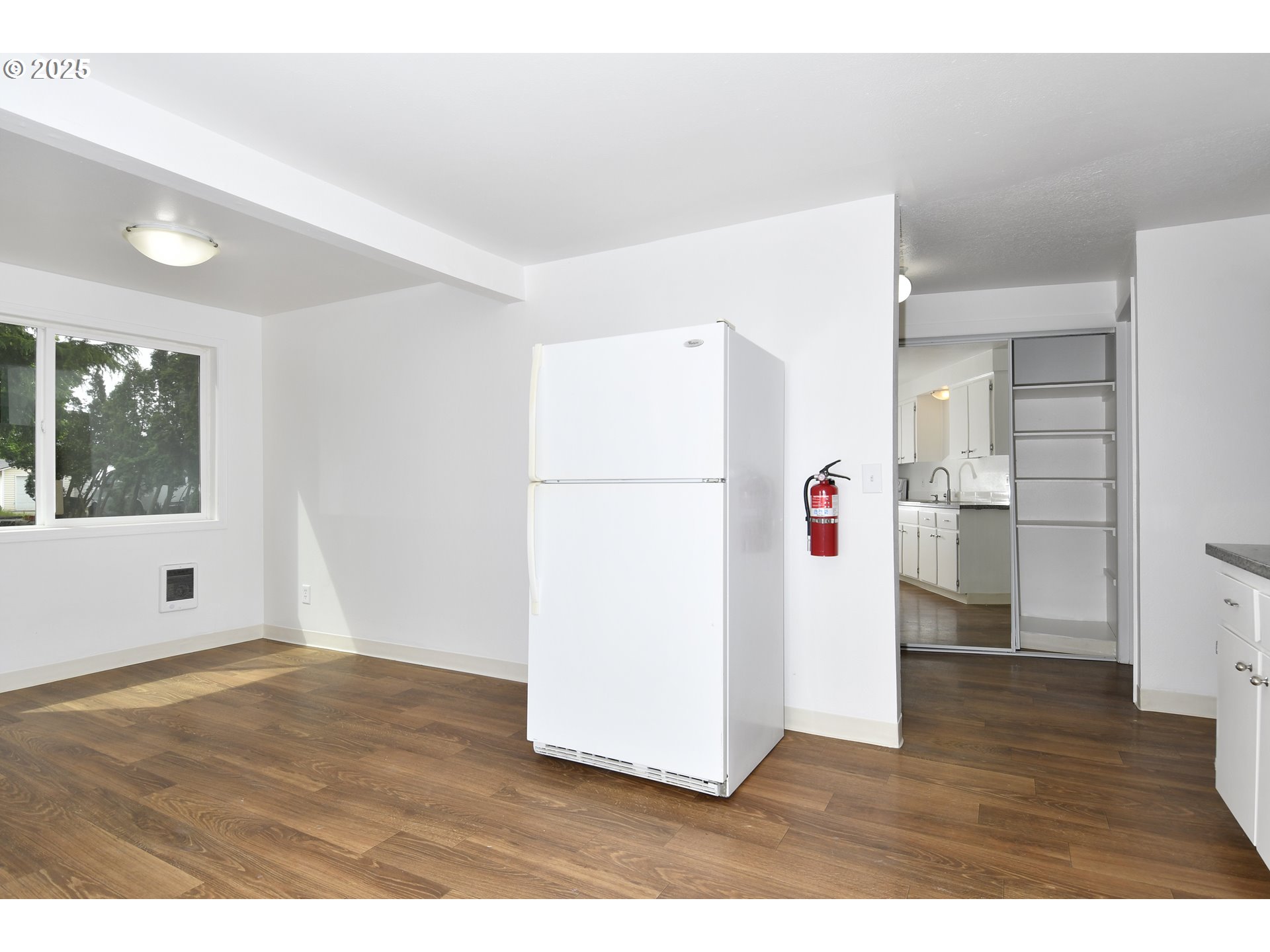 1126 South Jasper Street Cornelius, OR 97113 - Photo 32 of 47 a view of empty room with wooden floor and cabinets