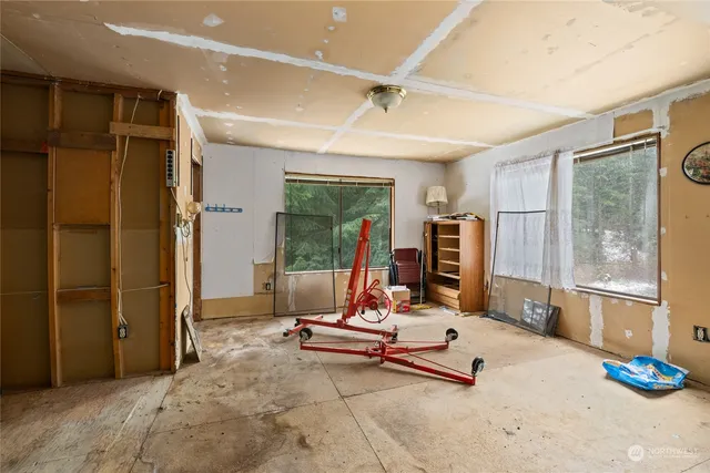 a living room with gym equipment and a large window