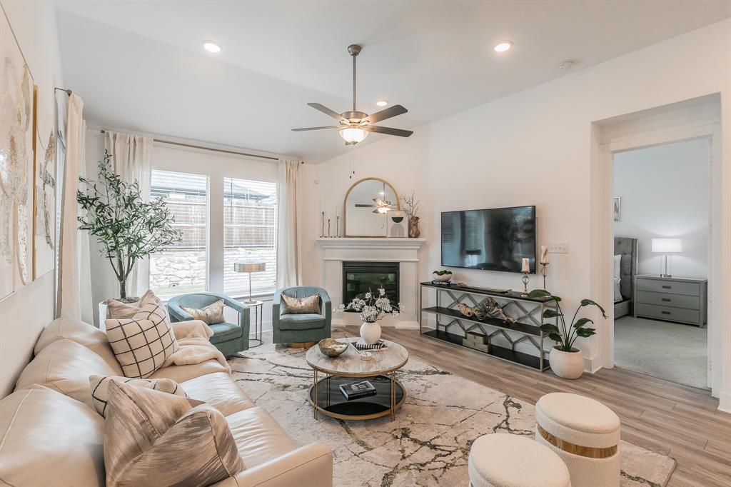 5404 Fairdale Drive Denton, TX 76207 - Photo 1 of 1 a living room with furniture a fireplace and a chandelier
