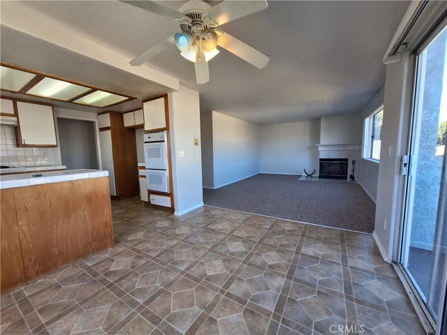 a view of empty room with a ceiling fan and window
