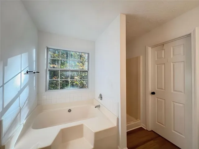 a bathroom with a bathtub and shower